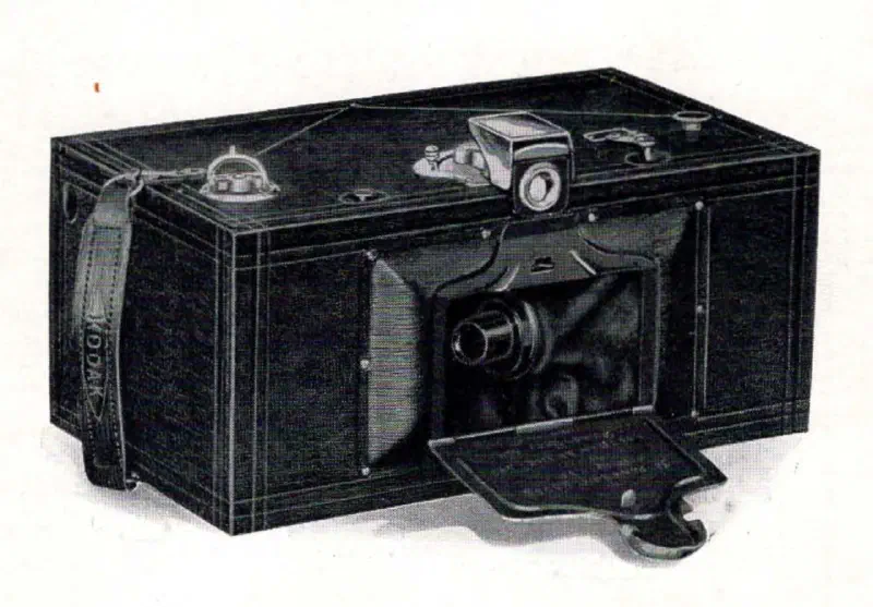 Three-quarter view of a Kodak Panoram 3A model panoramic camera showing the rotating lens and open lens cover flap.