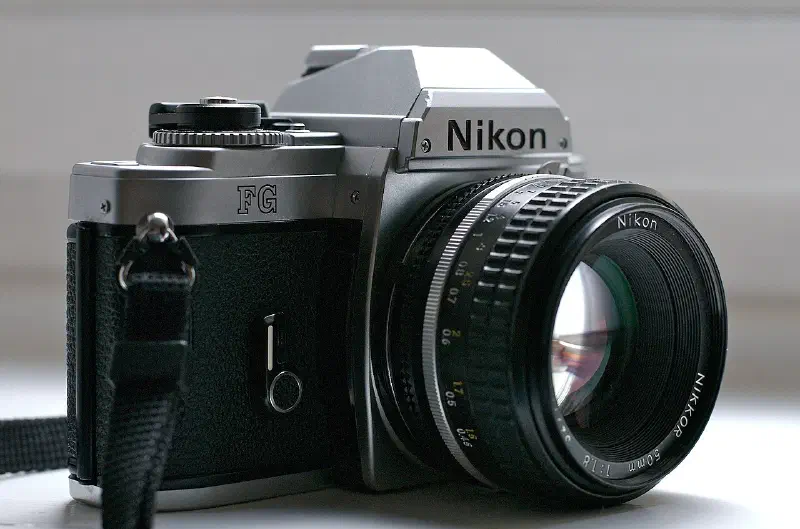 Photograph of a Nikon FG classic SLR photographic camera with Nikkor 50 mm f/1.8 lens