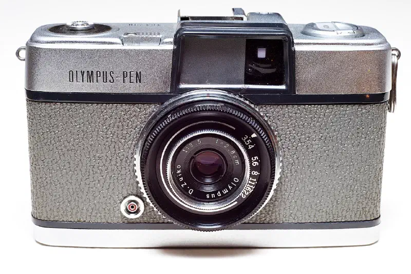 An original, 1959 model Olympus Pen half-frame compact 35mm camera.