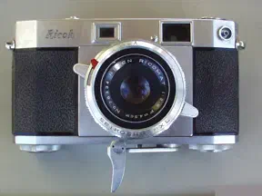 Front view of a Ricoh 500, 35 mm. rangefinder still camera.