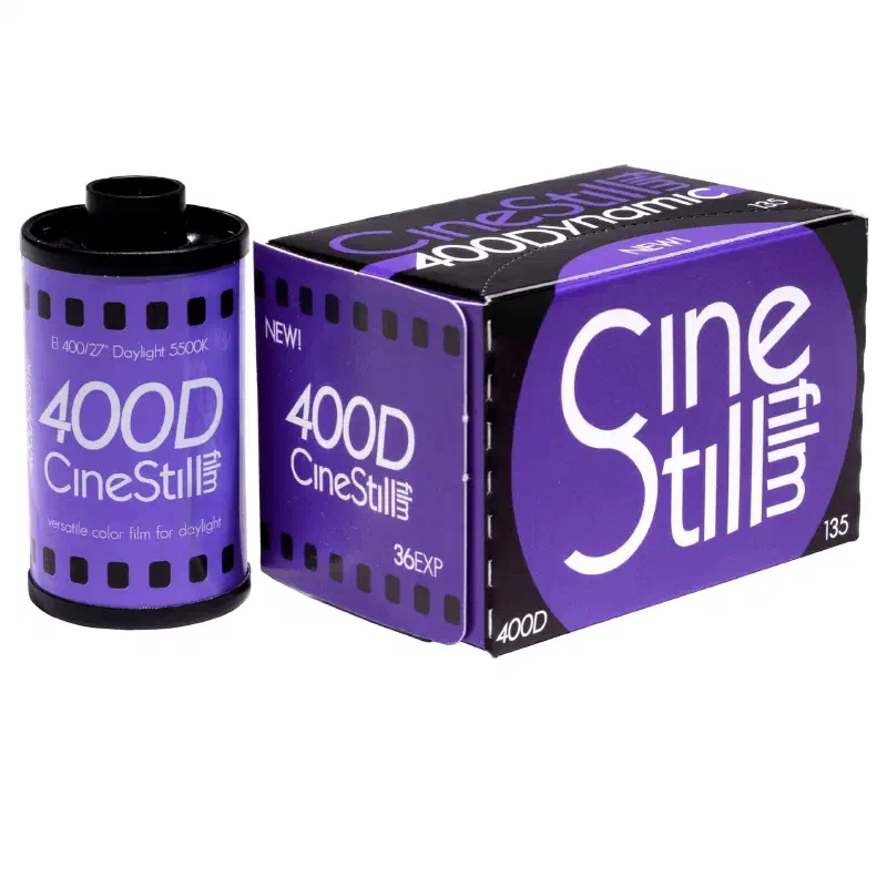 A 35 mm cassette of CineStill 400D beside its purple 135 box, both lettered in white