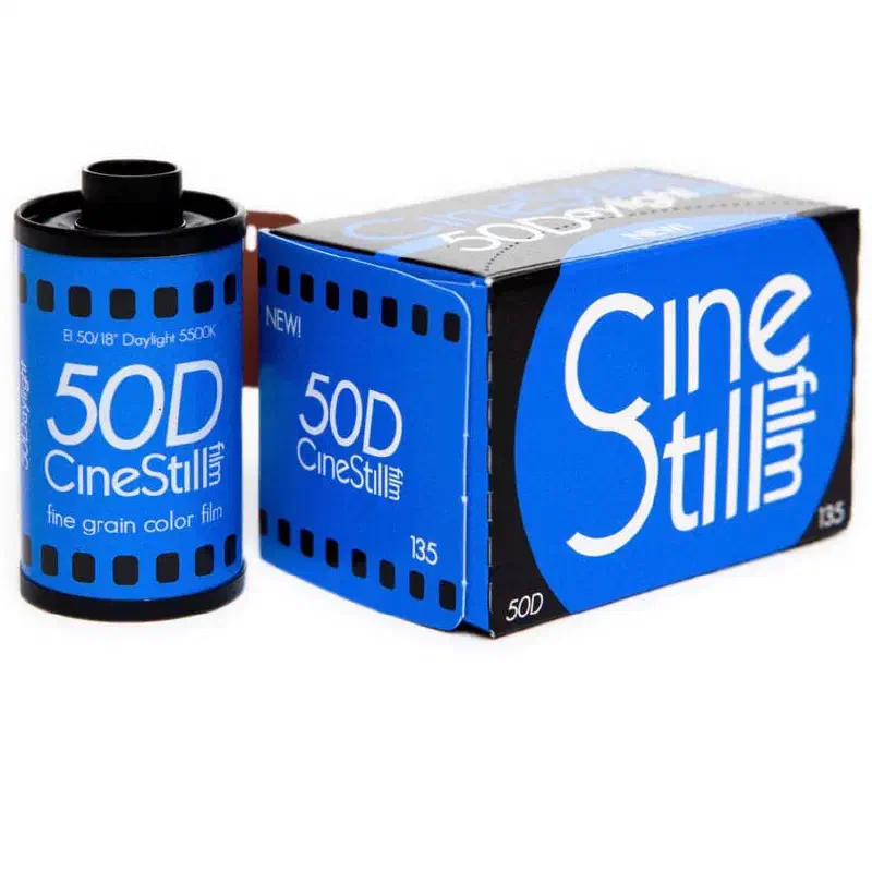 A 35 mm cassette of CineStill 50D beside its blue 135 box, both lettered in white