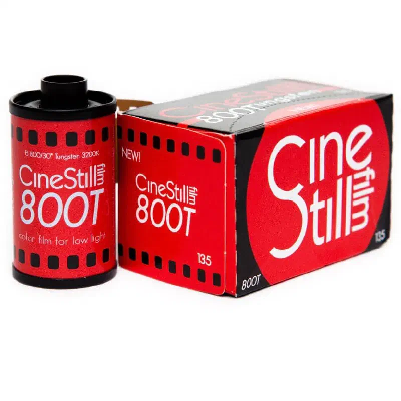 A 35 mm cassette of CineStill 800T beside its red 135 box, both lettered in white