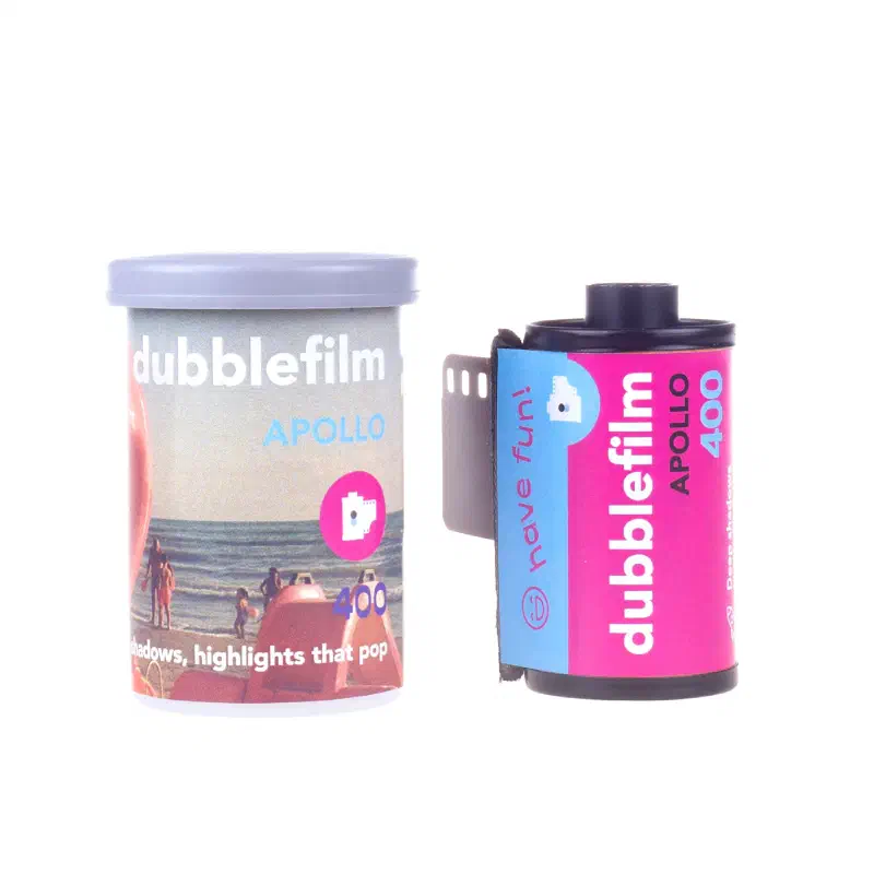A dubblefilm Apollo 400 canister and 35 mm cassette on white, the canister showing a beach scene