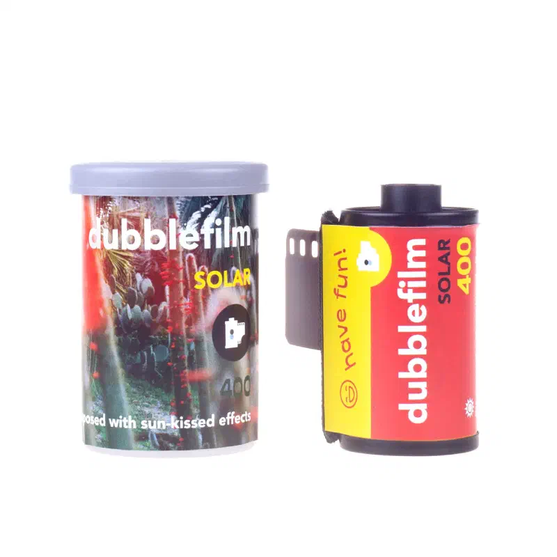 A dubblefilm Solar 400 canister and 35 mm cassette on white, the canister showing cacti under red-tinted light