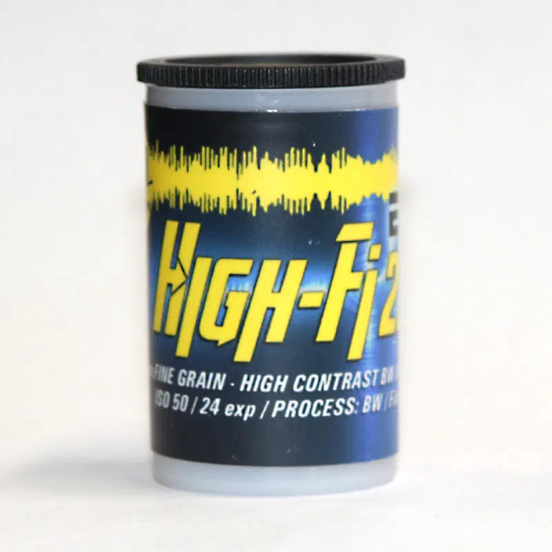 A 35 mm canister in blue and yellow lettered High-Fi 2374 over an audio waveform, marked FINE GRAIN - HIGH CONTRAST, ISO 50 / 24 exp / PROCESS: BW
