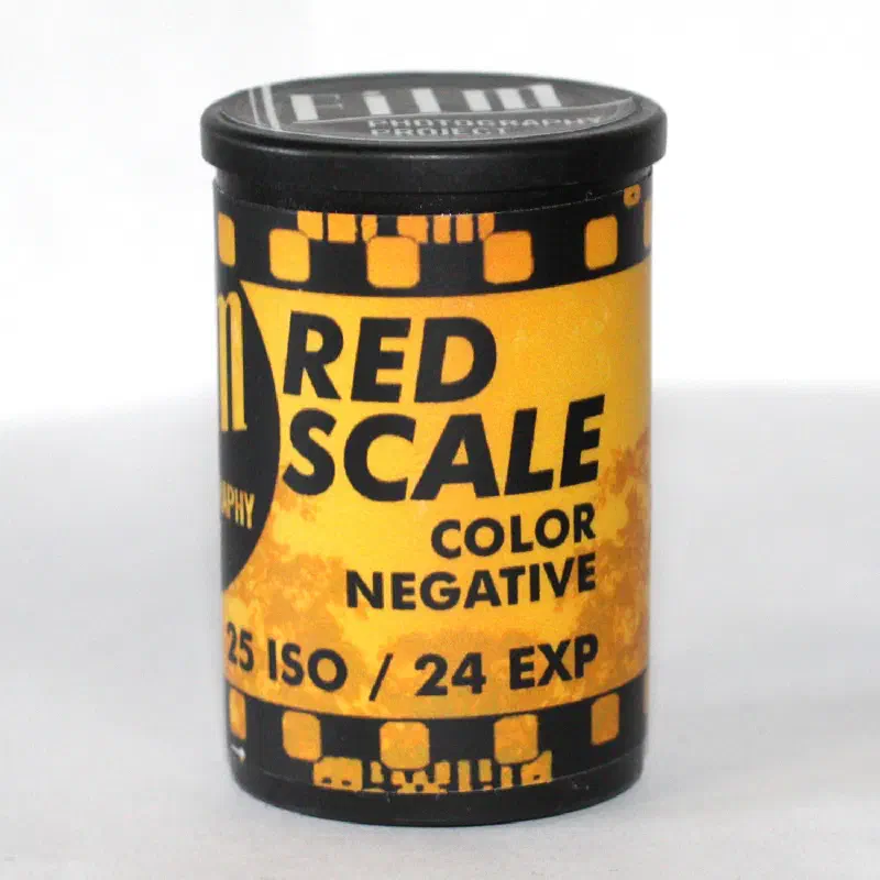 A black FPP canister with an orange Red Scale label, 25 ISO, 24 exposures