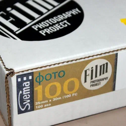 A white Film Photography Project box seen from a front corner, its gold label reading Svema ФОТО 100, 35mm x 30m (100 Ft), 100 asa