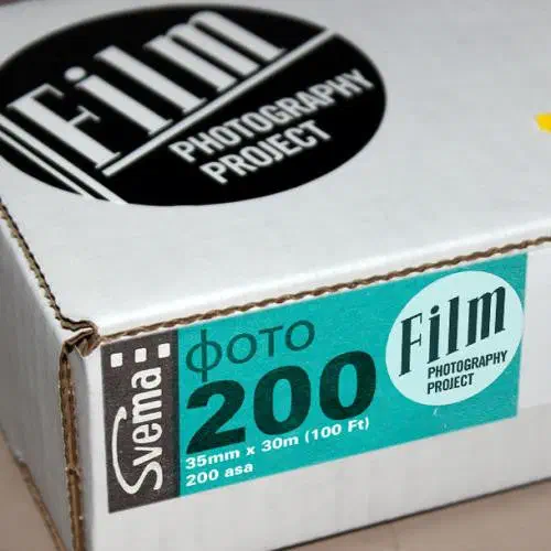 A white Film Photography Project box seen from a front corner, its teal label reading Svema ФОТО 200, 35mm x 30m (100 Ft), 200 asa