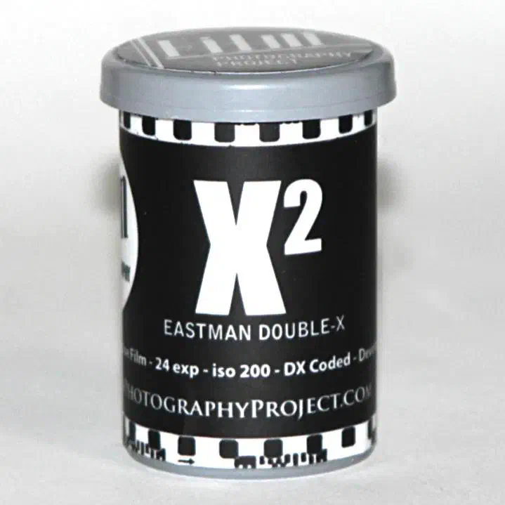 A black 35 mm canister with a sprocket-hole border lettered X² over EASTMAN DOUBLE-X, marked 24 exp - iso 200 - DX Coded and FILMPHOTOGRAPHYPROJECT.COM