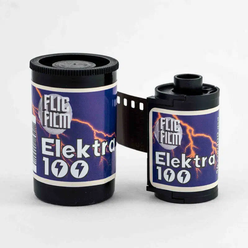 A 35 mm canister and cassette of FLIC FILM Elektra 100 side by side, orange lightning across a violet label, marked 36 exp 100 asa