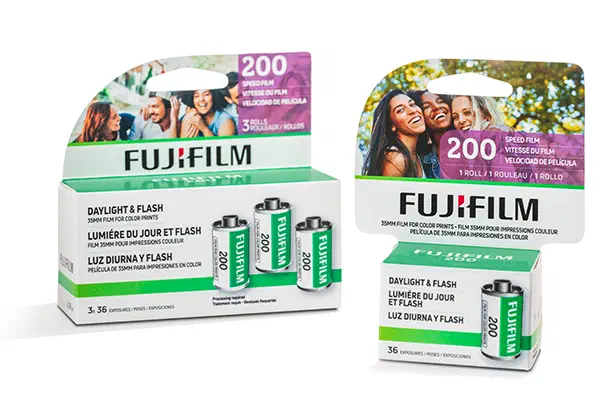 A FUJIFILM 200 three-pack in a green and white carton beside a single carton and two 35 mm cassettes, marked DAYLIGHT & FLASH and 36 exposures