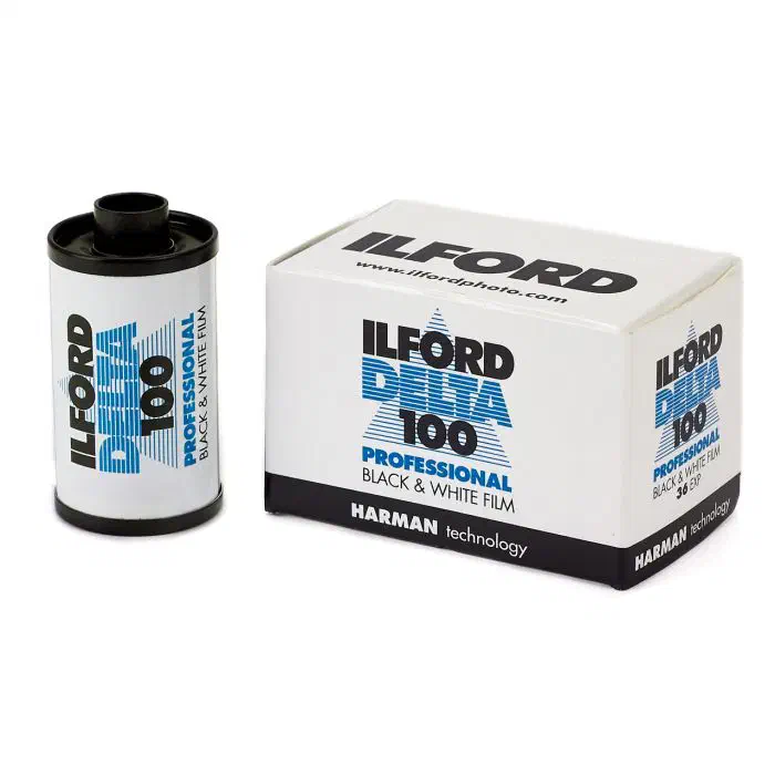 A 35 mm cassette of ILFORD DELTA 100 Professional beside its 36-exposure carton, lettered in blue