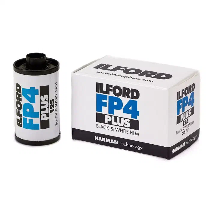A 35 mm cassette of ILFORD FP4 PLUS 125 beside its 36-exposure carton, lettered in blue