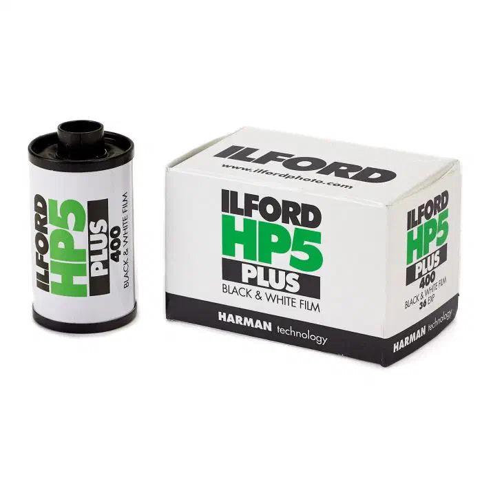 A 35 mm cassette of ILFORD HP5 PLUS 400 beside its 36-exposure carton, lettered in green