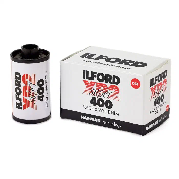 A 35 mm cassette of ILFORD XP2 SUPER 400 beside its 36-exposure carton, lettered in red and marked C41