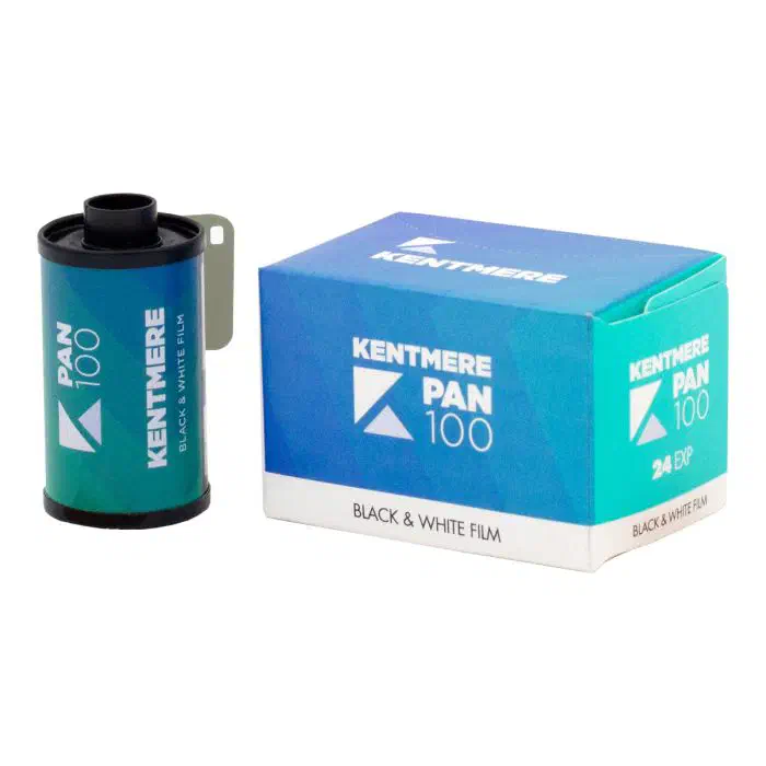 A 35 mm cassette of KENTMERE PAN 100 beside its 24-exposure carton, both in a blue-to-teal gradient