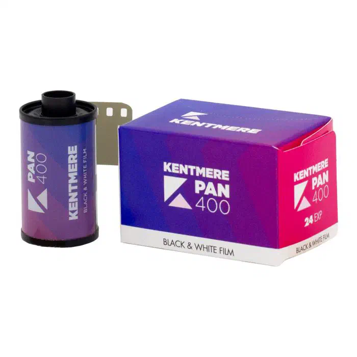 A 35 mm cassette of KENTMERE PAN 400 beside its 24-exposure carton, both in a blue-to-magenta gradient