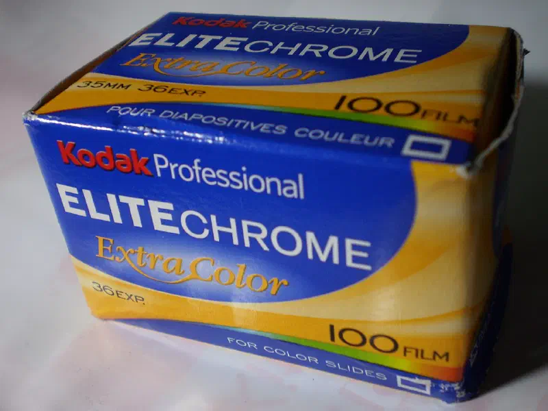 A blue and yellow Kodak Professional ELITECHROME ExtraColor carton seen from a front corner, marked 100 FILM and FOR COLOR SLIDES
