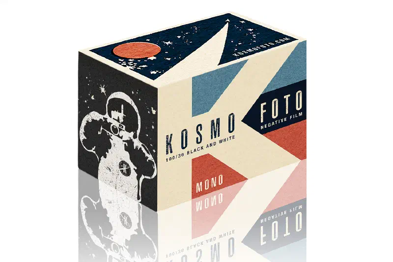 A cream, blue and red Kosmo Foto Mono box, printed with a cosmonaut holding a camera
