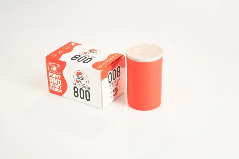 A red and white SantaColor 800 box beside a red film canister