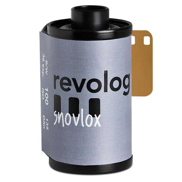 A 35 mm cassette of REVOLOG SNOVLOX, its silver-grey label carrying the revolog wordmark