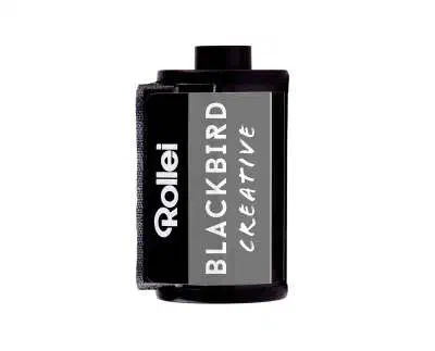 A 35 mm cassette of Rollei BLACKBIRD CREATIVE, black label lettered in white with a grey panel