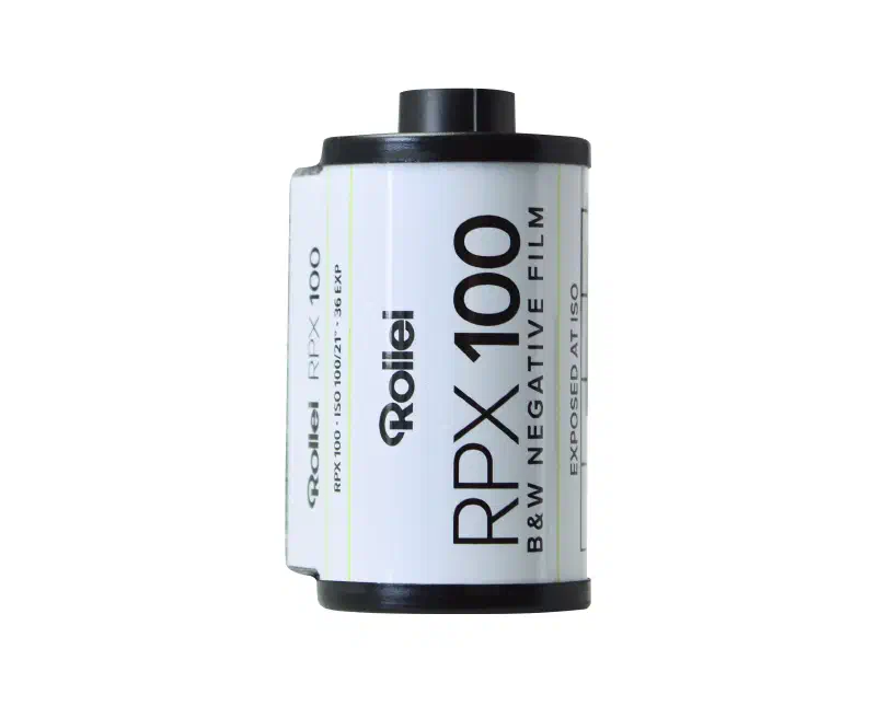 A 35 mm cassette of Rollei RPX 100, white label lettered in black and ruled with fine green lines, marked B&W NEGATIVE FILM and EXPOSED AT ISO