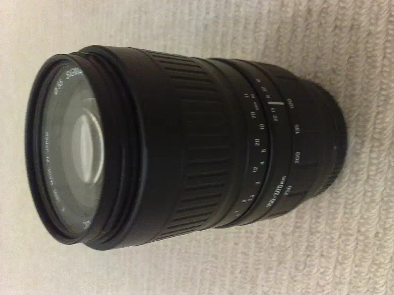Sigma 100–300mm f/4.5-6.7 DL, photographed on its own, off the camera